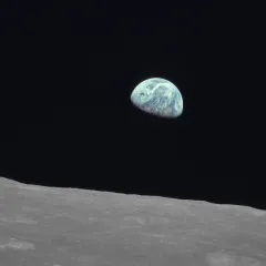Planet Earth seen from space with the cratered surface of the Moon in the foreground