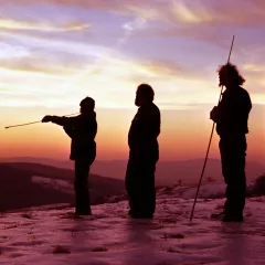 Dennis Stanford and other anthropologists practicing the use of atlatls in the sunset