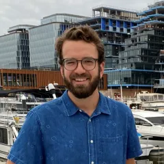 Carl Johnson, a bearded male wearing glasses and a blue shirt