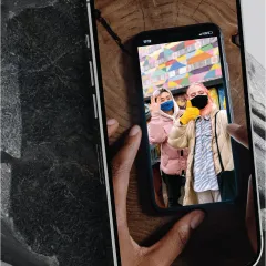 an image of a cellphone taking a picture of a cellphone photo of two women wearing masks