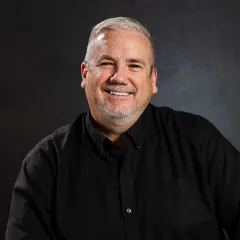 Dennis Hasch wearing a dark, button-down shirt