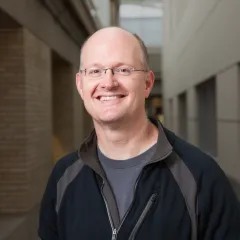 A pleasant-looking man smiles at the camera