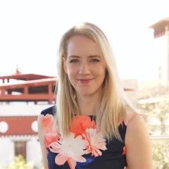 A light-skinned woman in a flower dress