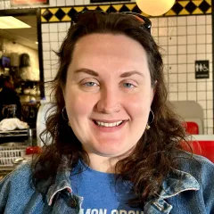 Woman with dark hair wearing a jean jacket