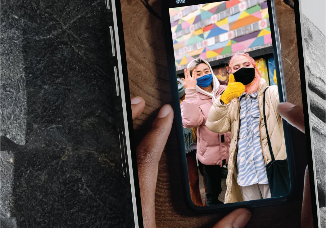 an image of a cellphone taking a picture of a cellphone photo of two women wearing masks