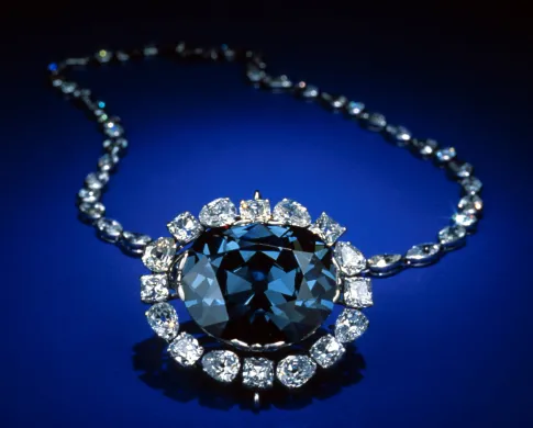 A blue diamond necklace on a blue background