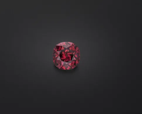 Red diamond gem on a black background