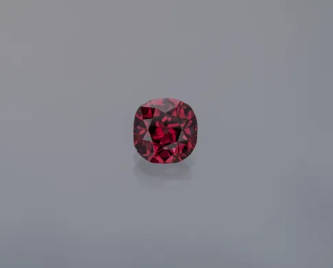 Red diamond gem on a gray background