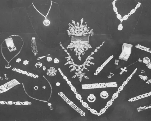 A collection of bracelets, necklaces, and earrings on a black backdrop