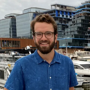 Carl Johnson, a bearded male wearing glasses and a blue shirt