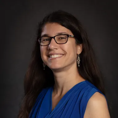 Profile photo of a woman with medium skin tone and long dark hair