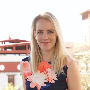 A light-skinned woman in a flower dress