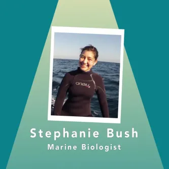 Stephanie Bush, marine biologist, in a wetsuit with the ocean behind her