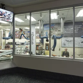 image of three paleontologists preparing fossils in a lab