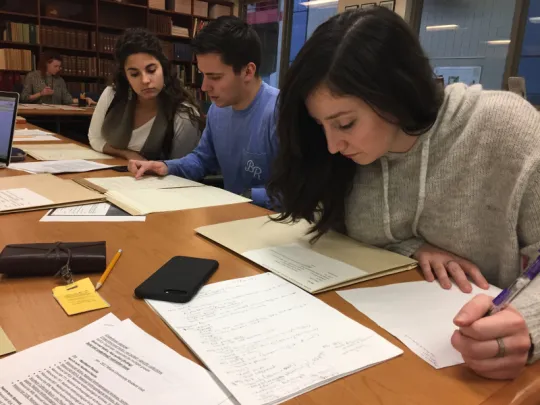 People examining archival material.