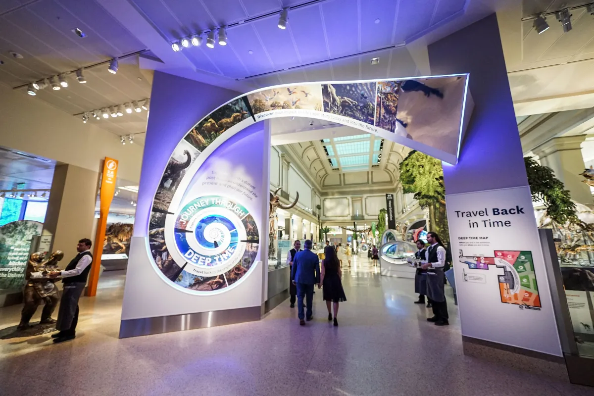 Guests mingle at a cocktail reception in the Fossil Hall