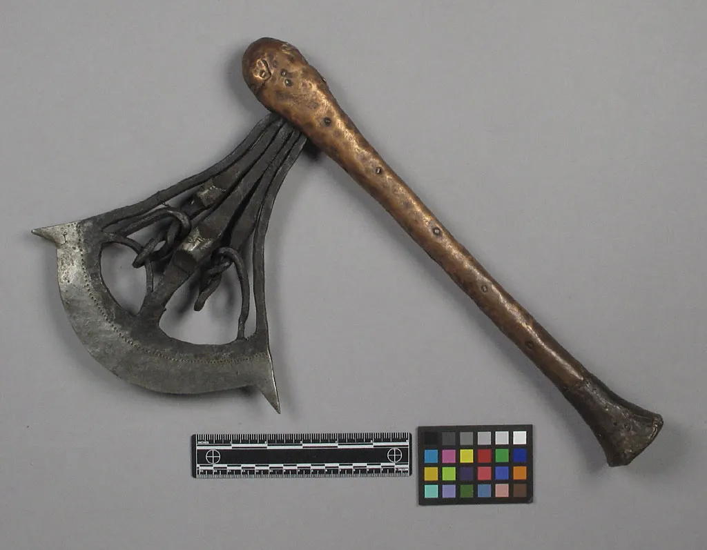 A heavy iron blade with five intricately worked iron rods. Wooden handle sheathed in copper.