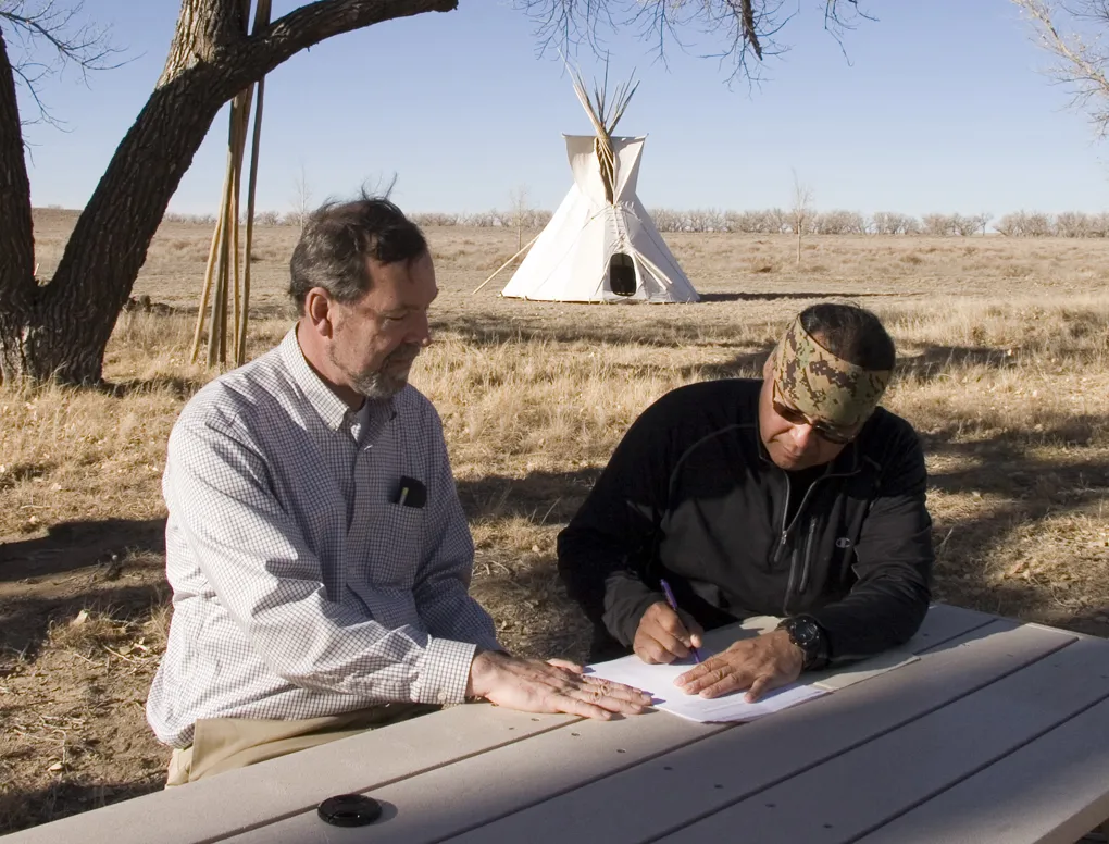 Otto Braided Hair signing documents, with Bill Billeck